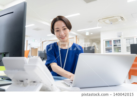 A middle-aged businesswoman working in an office A middle-aged businesswoman working in an office 140042015