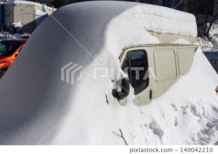 Van engulfed in snow, looking like a frosty sculpture. A rare winter sight, captured with dramatic lighting and texture, Russia Van engulfed in snow, looking like a frosty sculpture. A rare winter sight, captured with dramatic lighting and texture, Russia 140042210