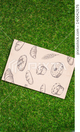 brown paper bag on Green Bush Trees Foliage Background. Eco Nature Friendly Style,Go to zero waste ecological shopping bag on the green grass. An alternative to disposable packages. Zero waste concept brown paper bag on Green Bush Trees Foliage Background. Eco Nature Friendly Style,Go to zero waste ecological shopping bag on the green grass. An alternative to disposable packages. Zero waste concept 140042676