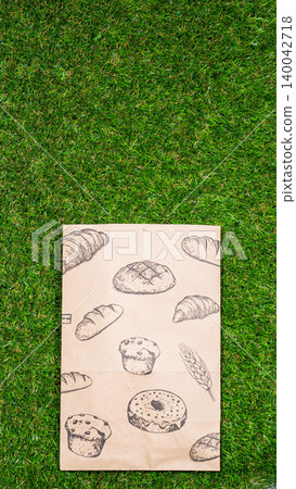 brown paper bag on Green Bush Trees Foliage Background. Eco Nature Friendly Style,Go to zero waste ecological shopping bag on the green grass. An alternative to disposable packages. Zero waste concept brown paper bag on Green Bush Trees Foliage Background. Eco Nature Friendly Style,Go to zero waste ecological shopping bag on the green grass. An alternative to disposable packages. Zero waste concept 140042718