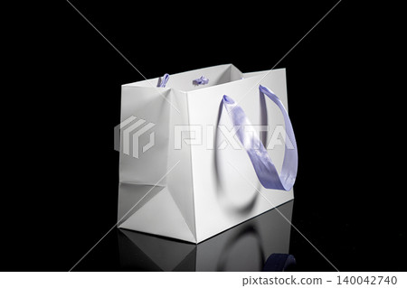 Recyclable craft paper bag for purchases, gifts and takeaway food mock up on black background. Environmentally friendly than single-use plastic bags 140042740