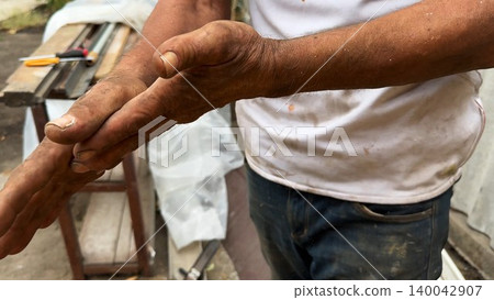Close up of male dirty hands of adult labor at construction. Repairman rubbing unclean arms after hard work at the site. Concept of exhausting and hard work. Slow motion Close up of male dirty hands of adult labor at construction. Repairman rubbing unclean arms after hard work at the site. Concept of exhausting and hard work. Slow motion 140042907