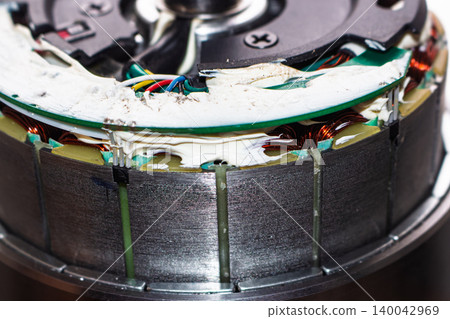 Close-up of a geared hub motor stator showcasing intricate copper windings, Hall sensors, and wiring Close-up of a geared hub motor stator showcasing intricate copper windings, Hall sensors, and wiring 140042969
