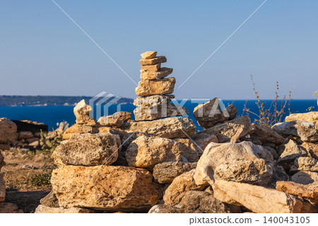 Stacked stone cairn on coastal rocks with Black Sea view at Cape Kaliakra Bulgaria Stacked stone cairn on coastal rocks with Black Sea view at Cape Kaliakra Bulgaria 140043105