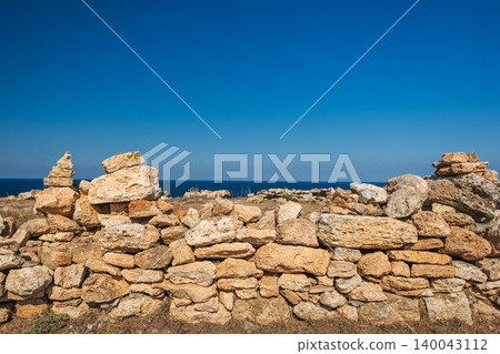 Ancient stone wall ruins near Black Sea coast under clear blue sky in Bulgaria Ancient stone wall ruins near Black Sea coast under clear blue sky in Bulgaria 140043112