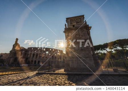 Sunset light over Colosseum and Arch of Constantine in Rome with dramatic lens flare Sunset light over Colosseum and Arch of Constantine in Rome with dramatic lens flare 140043114