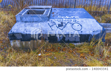 Rusty metal and overgrown grass setting. Moodful autumn scene with textured urban decay background Rusty metal and overgrown grass setting. Moodful autumn scene with textured urban decay background 140043341