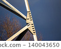 Robust power line tower fragment, its strong galvanized steel framework and bolted joints stark against a deep winter blue sky. Industrial engineering 140043650