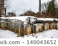 Deteriorated concrete and brick walls of a derelict building, blanketed in winter snow. A raw scene of urban abandonment, Russia 140043652