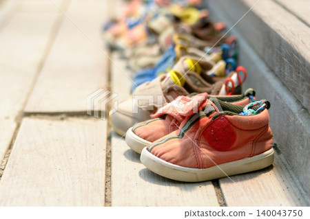 The sight of children's shoes as they head to daycare. 140043750