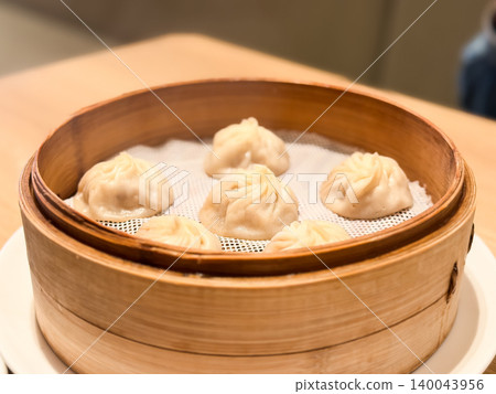 Steamed dishes. Xiao Long Bao, a Taiwanese dish, is made by steaming in a bamboo steamer. Steamed dishes. Xiao Long Bao, a Taiwanese dish, is made by steaming in a bamboo steamer. 140043956