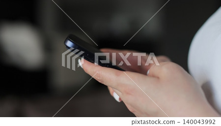 Hand of woman using texting mobile phone or chat. Close up of woman hand. Hand of woman using texting mobile phone or chat. Close up of woman hand. 140043992