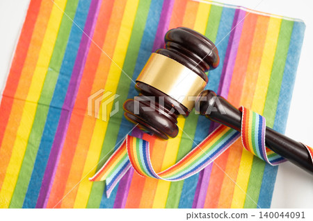 Gavel for judge lawyer on rainbow flag, symbol of LGBT pride month. Gavel for judge lawyer on rainbow flag, symbol of LGBT pride month. 140044091