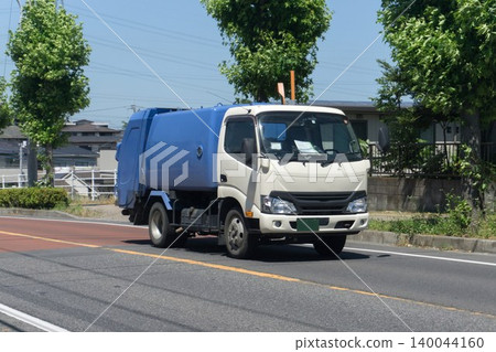 A garbage truck in motion. A garbage truck in motion. 140044160