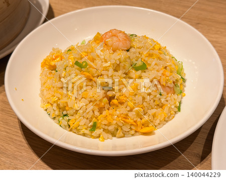 Shrimp fried rice made by stir-frying shrimp, eggs, vegetables, and rice. It's piled high on the plate. Shrimp fried rice made by stir-frying shrimp, eggs, vegetables, and rice. It's piled high on the plate. 140044229