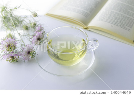 Pink nigella, herbal tea, and reading time: A natural lifestyle. Pink nigella, herbal tea, and reading time: A natural lifestyle. 140044649