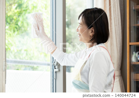 A woman cleaning windows A woman cleaning windows 140044724