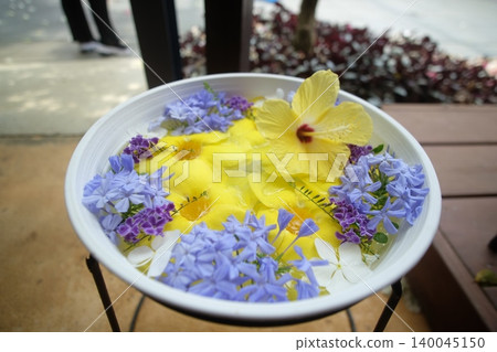 Allamanda, hibiscus, and duranta floating on the water Allamanda, hibiscus, and duranta floating on the water 140045150