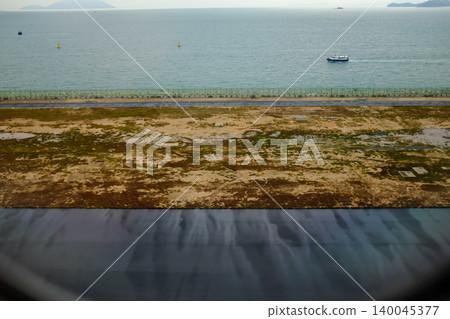 Looking from the airplane window of the landing scene. The scene of the airport apron. Travel and transportation concept. 140045377