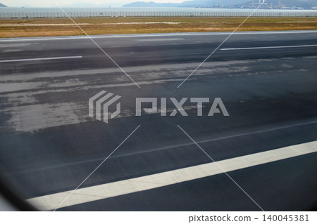 Looking from the airplane window of the landing scene. The scene of the airport apron. Travel and transportation concept. 140045381