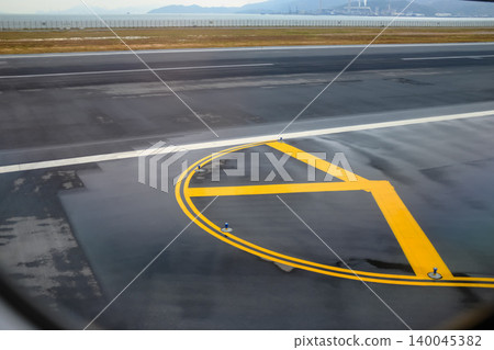 Looking from the airplane window of the landing scene. The scene of the airport apron. Travel and transportation concept. 140045382