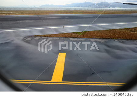 Looking from the airplane window of the landing scene. The scene of the airport apron. Travel and transportation concept. Looking from the airplane window of the landing scene. The scene of the airport apron. Travel and transportation concept. 140045383