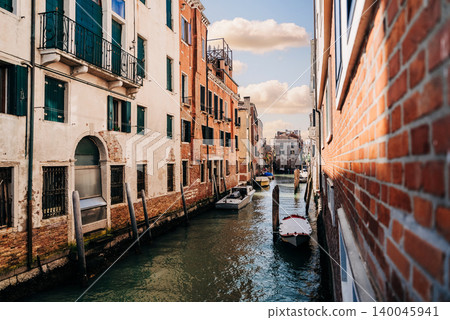 Sunny Venetian Canal With Traditional Stone Bridge and Old Buildings Sunny Venetian Canal With Traditional Stone Bridge and Old Buildings 140045941