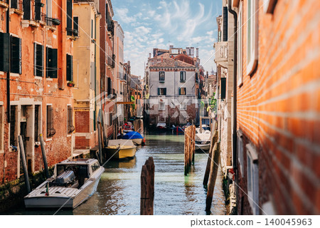 Venice Canal from pier with boats and warm light. Timeless beauty of city Venice Canal from pier with boats and warm light. Timeless beauty of city 140045963