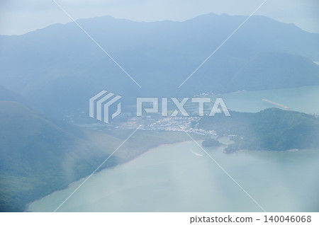 Looking through airplane window with the view of Hong Kong scene. Hong Kong rural area, Hong Kong Mountains from the high angle view. Nature scene. Looking through airplane window with the view of Hong Kong scene. Hong Kong rural area, Hong Kong Mountains from the high angle view. Nature scene. 140046068