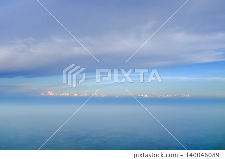 Looking through airplane window with dramatic cloudscape. white clouds with the blue sky from the high angle view. Cloudscape background. Nature scene. Looking through airplane window with dramatic cloudscape. white clouds with the blue sky from the high angle view. Cloudscape background. Nature scene. 140046089