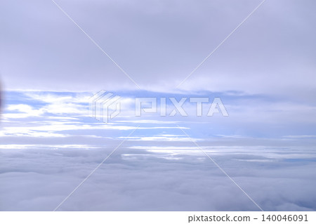 Looking through airplane window with dramatic cloudscape. white clouds with the blue sky from the high angle view. Cloudscape background. Nature scene. Looking through airplane window with dramatic cloudscape. white clouds with the blue sky from the high angle view. Cloudscape background. Nature scene. 140046091