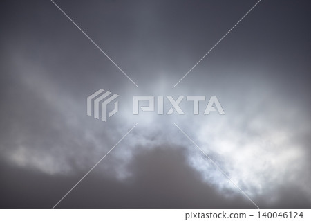 Cloudscape with gray clouds under the sky, strong sunbeam through the gray clouds. Overcast scene. Nature scene. Cloudscape with gray clouds under the sky, strong sunbeam through the gray clouds. Overcast scene. Nature scene. 140046124