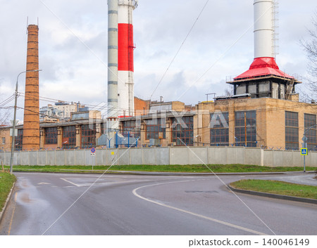 Curved pathway directs gaze toward factory structures with smokestacks and industrial skyline 140046149