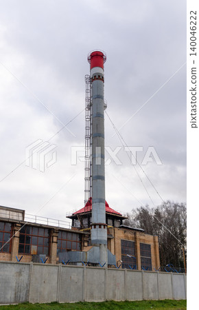 Maintenance operations on large metal stack involve scaffolding and detailed inspections in urban area Maintenance operations on large metal stack involve scaffolding and detailed inspections in urban area 140046222