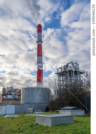 Urban structures against cloudy sky. Panoramic scene of industrial buildings and atmospheric clouds 140046226