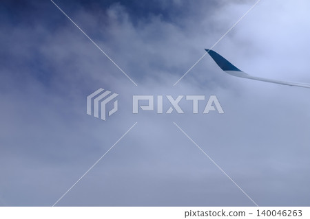 Cloudscape with gray clouds looking from the airplane window. Full of clouds. Overcast scene. Nature scene. For background use. Cloudscape with gray clouds looking from the airplane window. Full of clouds. Overcast scene. Nature scene. For background use. 140046263