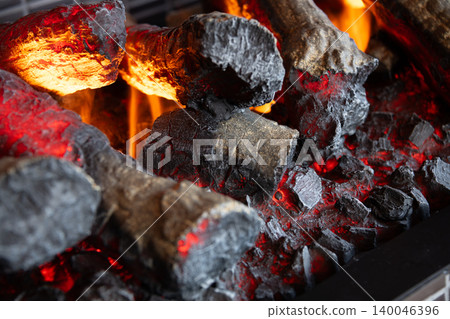 The image of burning logs in a fireplace The image of burning logs in a fireplace 140046396