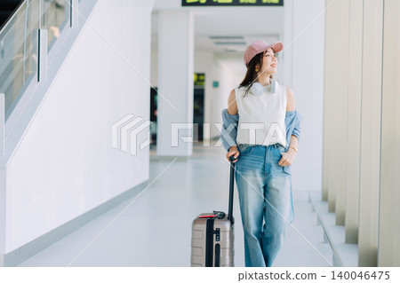 A woman departing from the airport on a trip. ("Filming assistance: Kobe Airport (UKB)") A woman departing from the airport on a trip. ("Filming assistance: Kobe Airport (UKB)") 140046475
