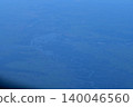 Looking through the airplane window with the view of cityscape under the clouds. Clouds above the city. Looking from aerial view. Nature and travel concept. 140046560
