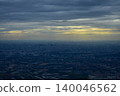 Looking through the airplane window with the view of cityscape under the clouds. Clouds above the city. Looking from aerial view. Nature and travel concept. 140046562