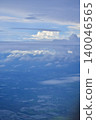 Looking through the airplane window with the view of cityscape under the clouds. Clouds above the city. Looking from aerial view. Nature and travel concept. 140046565