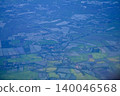Looking through the airplane window with the view of cityscape under the clouds. Clouds above the city. Looking from aerial view. Nature and travel concept. 140046568