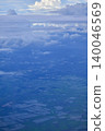 Looking through the airplane window with the view of cityscape under the clouds. Clouds above the city. Looking from aerial view. Nature and travel concept. 140046569
