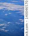 Looking through the airplane window with the view of cityscape under the clouds. Clouds above the city. Looking from aerial view. Nature and travel concept. 140046570