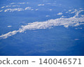 Looking through the airplane window with the view of cityscape under the clouds. Clouds above the city. Looking from aerial view. Nature and travel concept. 140046571