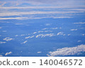 Looking through the airplane window with the view of cityscape under the clouds. Clouds above the city. Looking from aerial view. Nature and travel concept. 140046572
