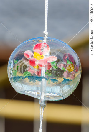 A cool glass wind chime with a floral pattern. A cool glass wind chime with a floral pattern. 140046580