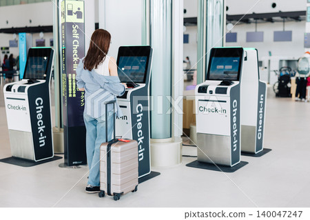 A woman self-checking in at the airport. (Photo courtesy of Kobe Airport (UKB)) A woman self-checking in at the airport. (Photo courtesy of Kobe Airport (UKB)) 140047247