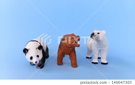 Panda and bear (ursidae) toys on a blue background. Panda and bear (ursidae) toys on a blue background. 140047305