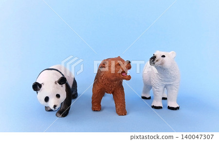 Panda and bear (ursidae) toys on a blue background. Panda and bear (ursidae) toys on a blue background. 140047307